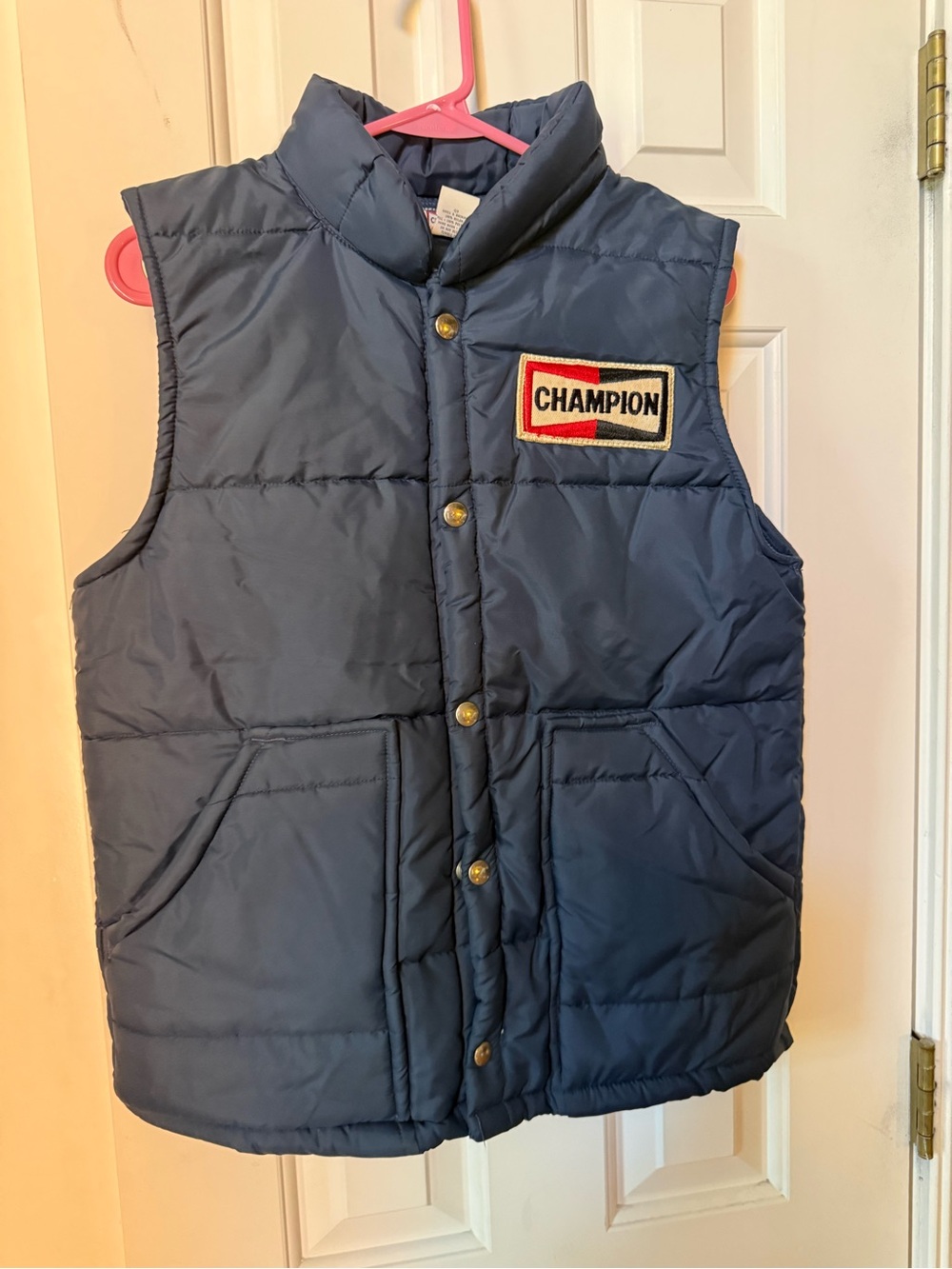 This item is a vintage 1970s/1980s Champion Spark Plug "Official Racing Apparel"